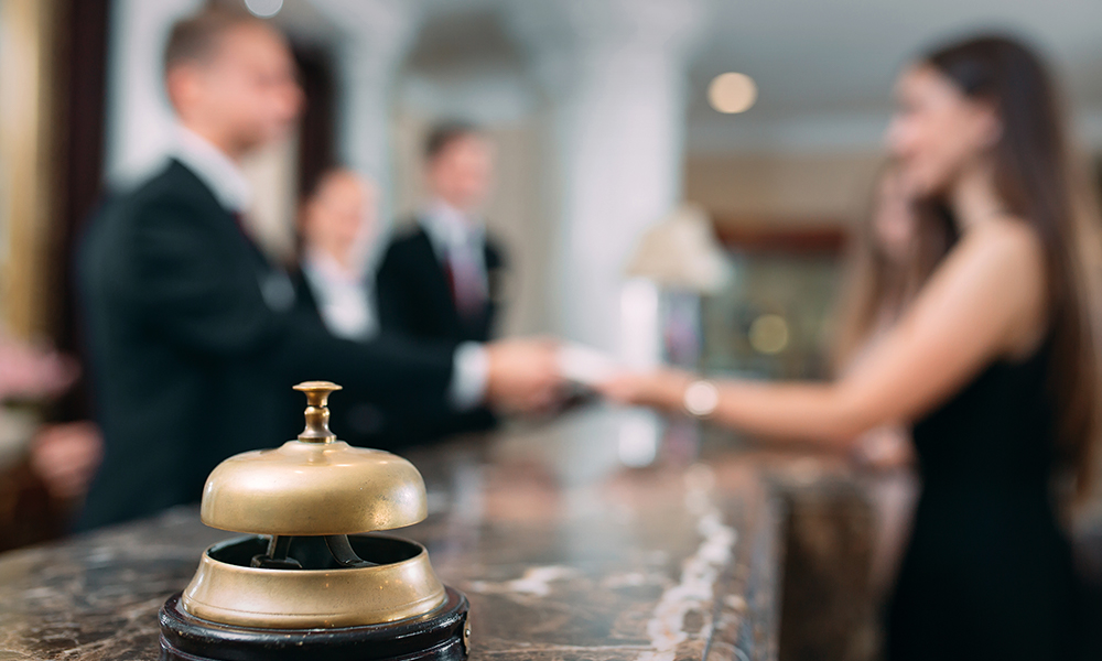 A hotel counter bell with blurred background: book your hotel