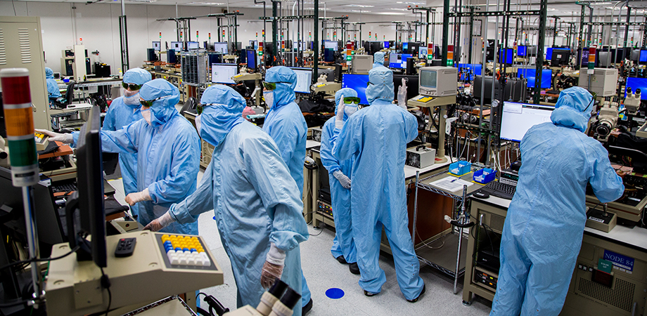 Workers at right in Finisar's wafer testing area. Apple has committed to buy $390 million of VCSELs from the photonics company. Credit:Finisar/Apple