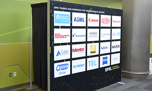 Wall of sponsor signage at SPIE event
