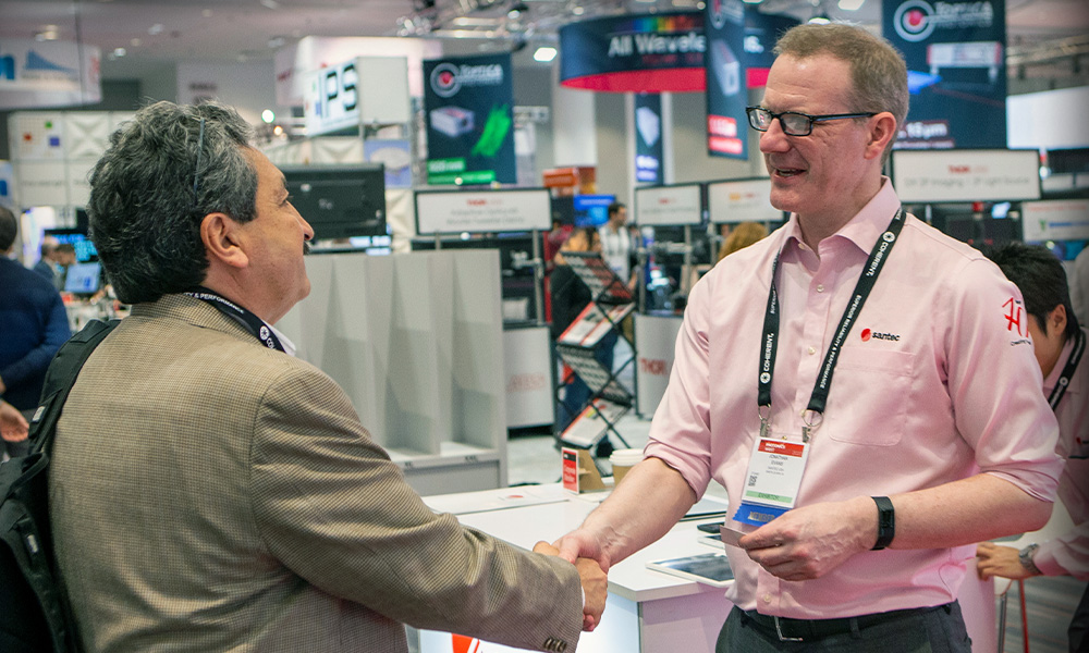 Exhibit hall attendees interact at SPIE event