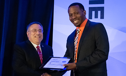 Honoring outstanding achievement by our researchers: The conference chair shakes the hand of an award winner
