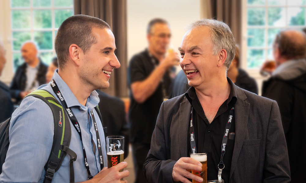 Attendees participating in networking and social events at SPIE Optics + Optoelectronics