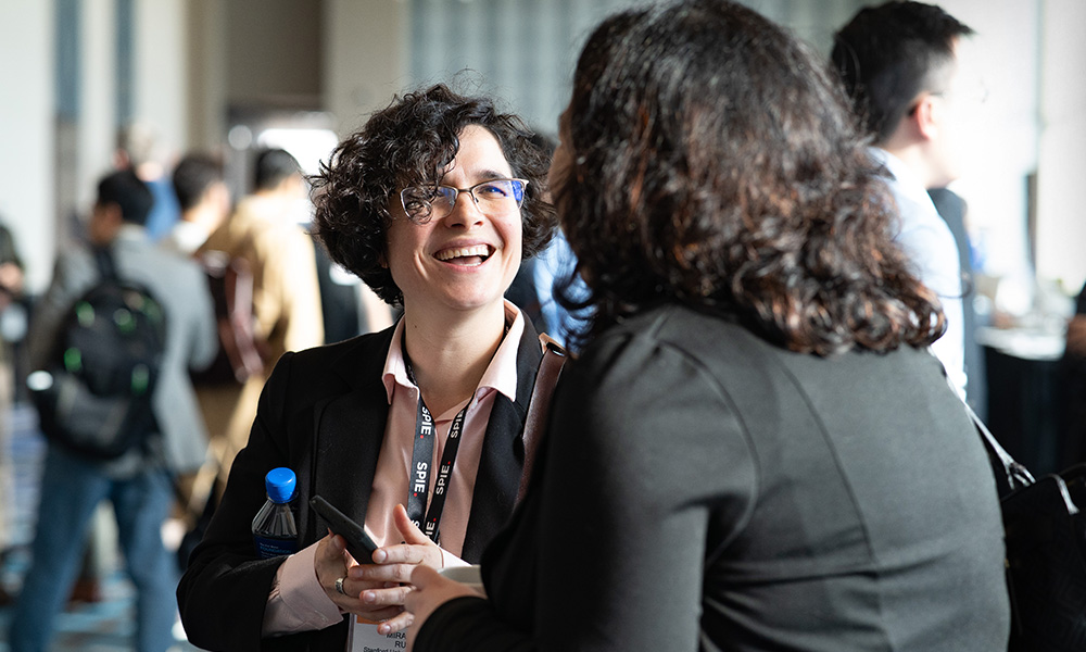 Two attendees enjoying a social interaction at a networking event
