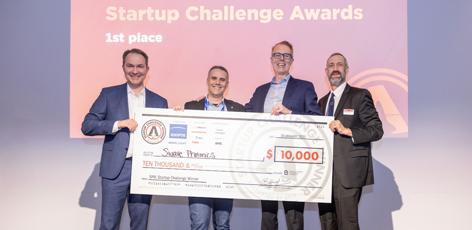 Jenoptik’s Ralf Kuschnereit, far left, Swave Co-Founder and Chief Product Officer Theo Marescaux, Swave CEO Mike Noonen, and 2023 SPIE Vice President Peter de Groot holding big check at 2023 SPIE Startup Challenge. Credit: Joey Cobbs