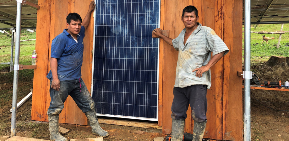Geider and Apu Miguel stand under the completed 7.2 kW array